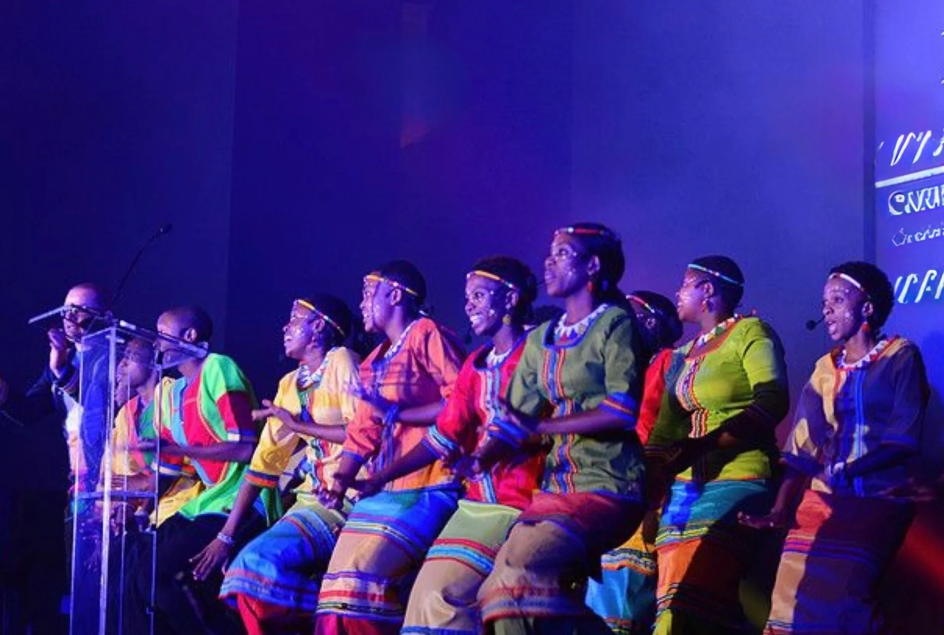 Performers on stage at a PLAYER charitable gala
